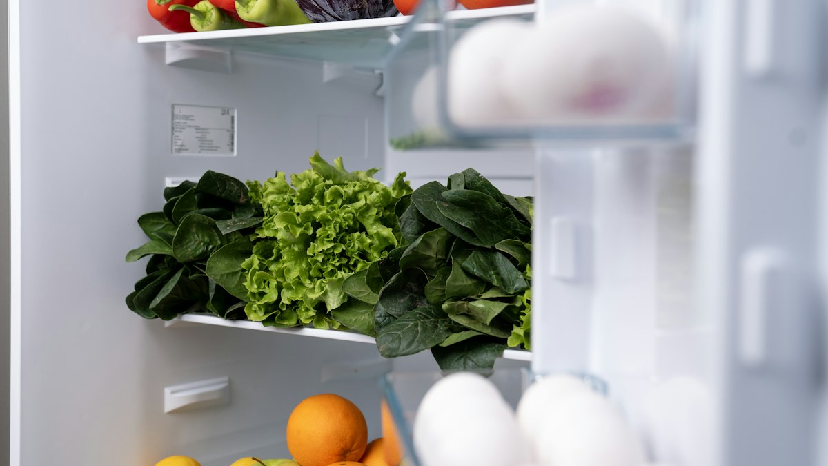 Refrigerator shelves and drawers filled with fresh fruits and vegetables